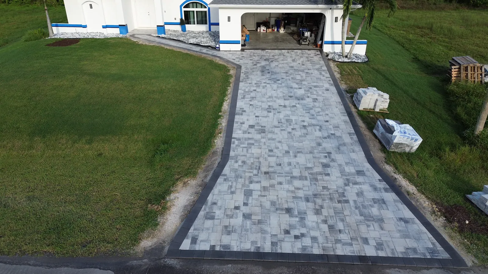 Paver driveway with a dark soldier-course border, Southwest Florida, by Blue Collar Q